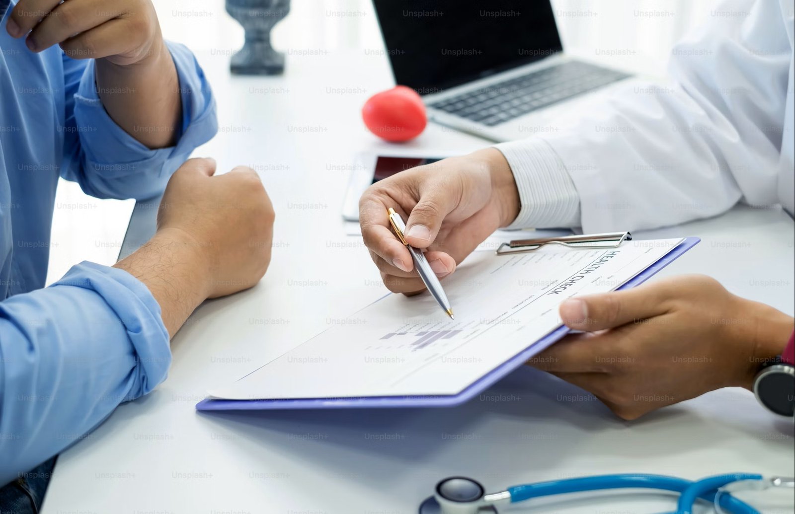 A doctor explaining medical results to a patient on a clipboard